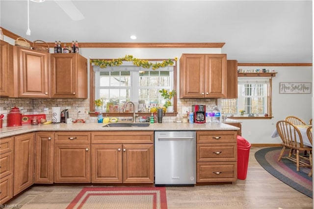 kitchen featuring ornamental molding, decorative backsplash, a sink, stainless steel dishwasher, and brown cabinets