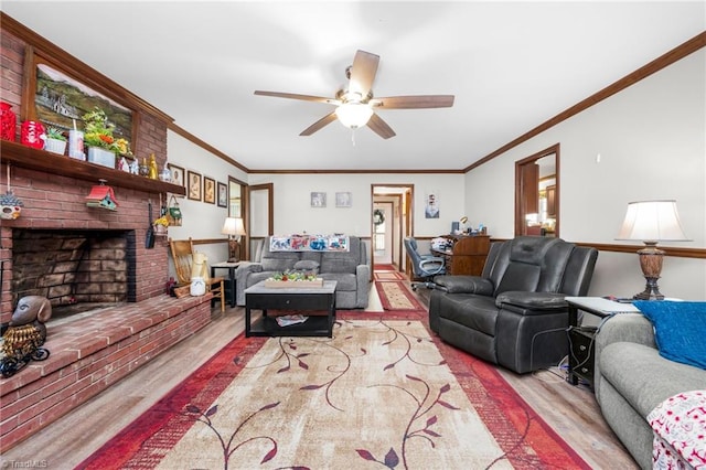 living room featuring ornamental molding, a brick fireplace, ceiling fan, and wood finished floors