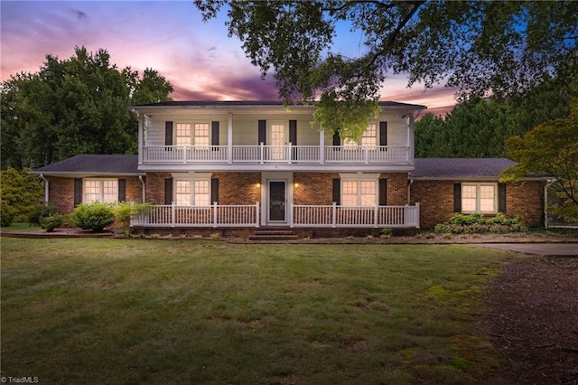 view of front of home featuring a yard and a porch