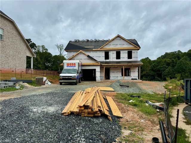 view of front of home with a garage and central air condition unit