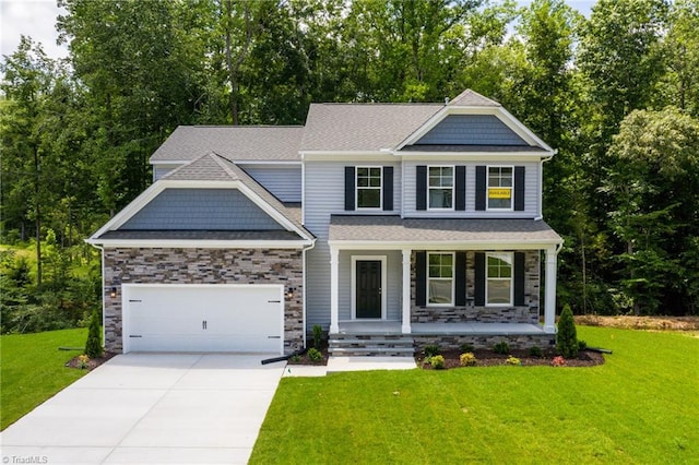 craftsman house featuring covered porch, a garage, and a front lawn