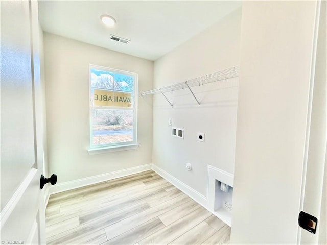 laundry area with gas dryer hookup, electric dryer hookup, washer hookup, and light hardwood / wood-style floors