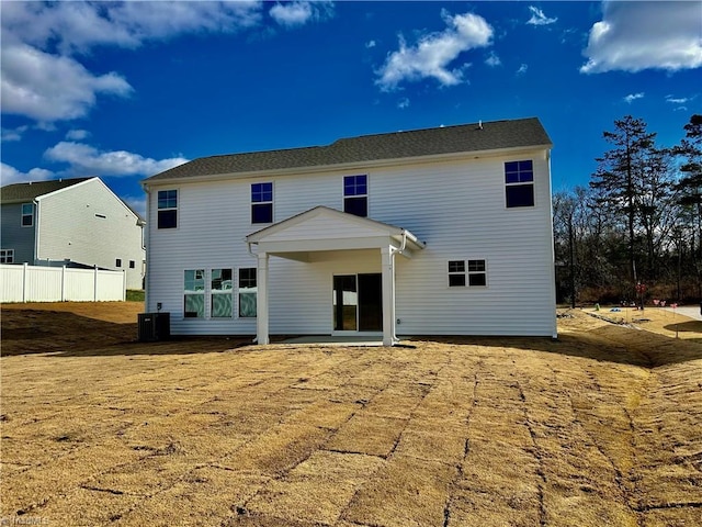 rear view of house featuring cooling unit and a patio area