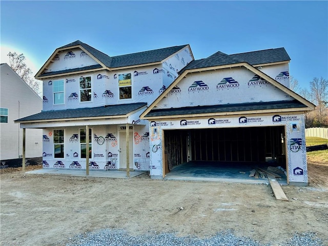 property in mid-construction with covered porch and a garage