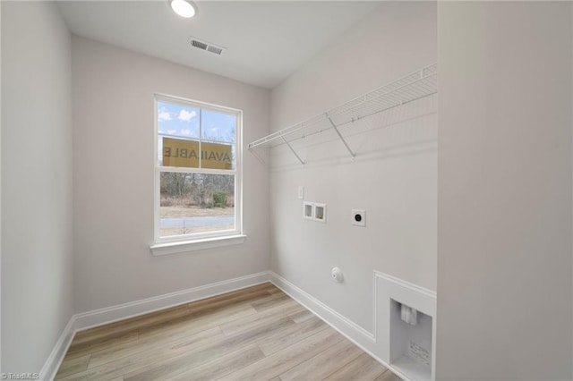 laundry room with gas dryer hookup, electric dryer hookup, washer hookup, and light hardwood / wood-style floors