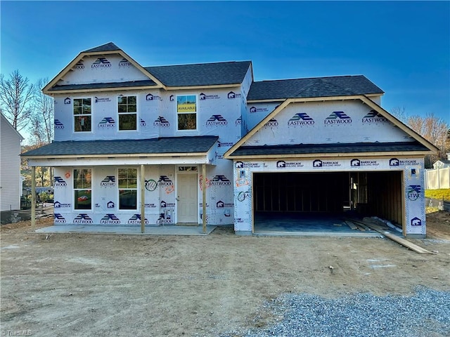 property in mid-construction featuring covered porch and a garage