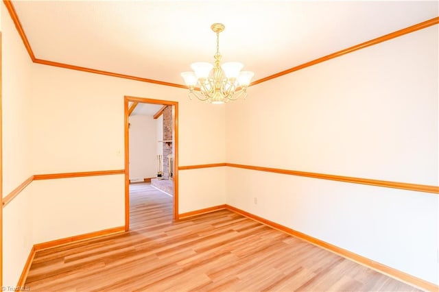 163 Ruth Ct, Winston-Salem, NC 27127 - empty room with a chandelier, light wood-style flooring, baseboards, and crown molding