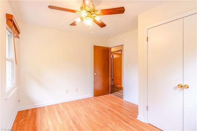 163 Ruth Ct, Winston-Salem, NC 27127 - unfurnished bedroom featuring light wood-type flooring, baseboards, a ceiling fan, and a closet