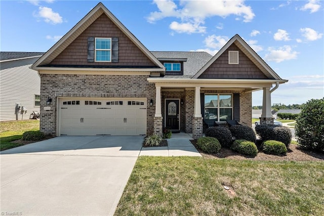 craftsman inspired home with a front yard, a garage, and a porch