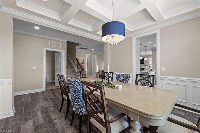 dining room featuring crown molding, coffered ceiling, dark hardwood / wood-style flooring, and a notable chandelier