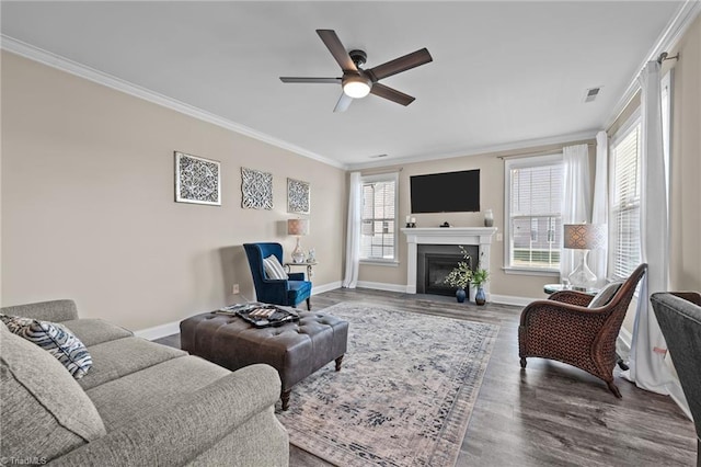 living room with a healthy amount of sunlight, crown molding, hardwood / wood-style floors, and ceiling fan