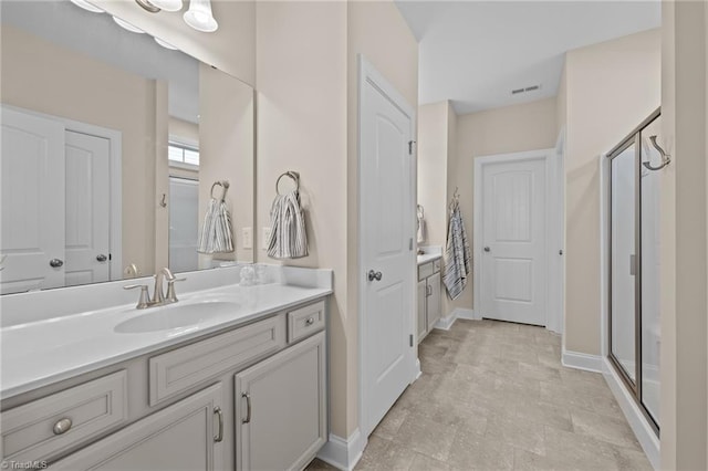 bathroom with a shower with door and vanity