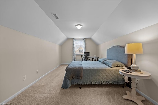 bedroom with carpet floors and lofted ceiling