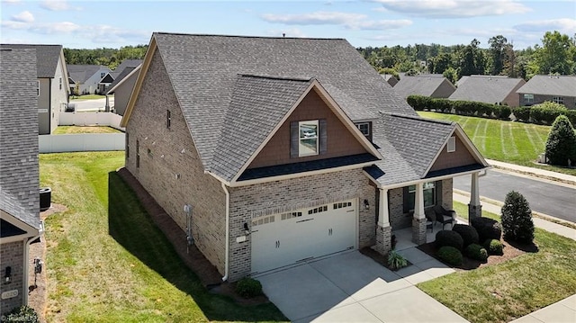 view of front of house with a garage and a front lawn