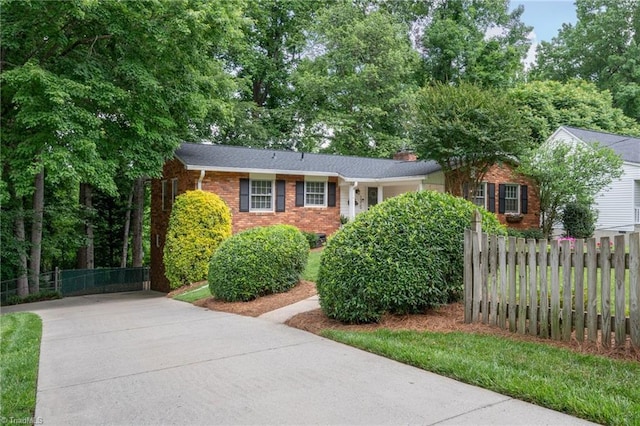 1315 Waybridge Ln, Winston-Salem, NC 27103 - view of front of house with driveway, brick siding, and a chimney