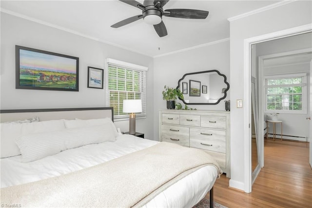 1315 Waybridge Ln, Winston-Salem, NC 27103 - bedroom with wood finished floors, multiple windows, crown molding, a baseboard radiator, and ceiling fan