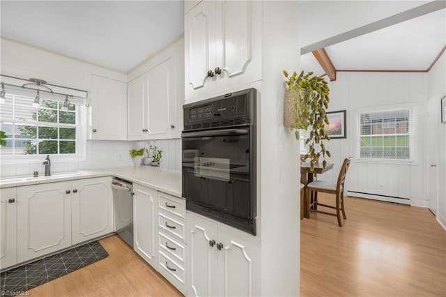 1315 Waybridge Ln, Winston-Salem, NC 27103 - kitchen with oven, dishwasher, a baseboard heating unit, light wood-type flooring, and white cabinets