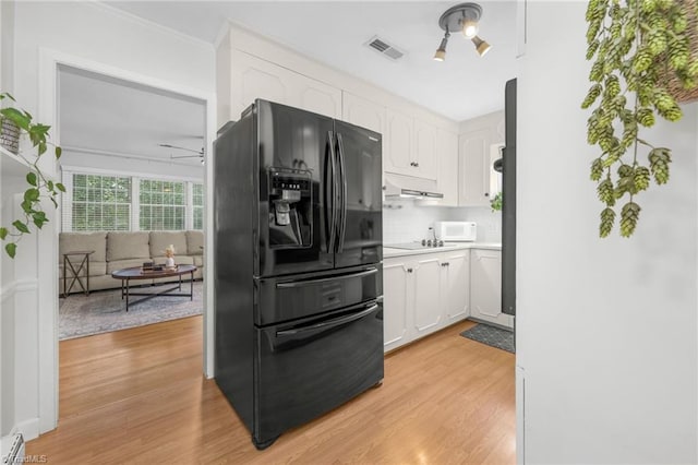 1315 Waybridge Ln, Winston-Salem, NC 27103 - kitchen featuring black appliances, white cabinets, light wood finished floors, light countertops, and crown molding
