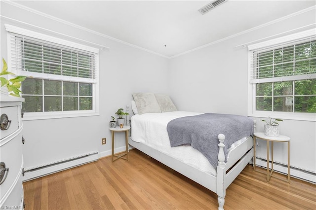 1315 Waybridge Ln, Winston-Salem, NC 27103 - bedroom with a baseboard heating unit, multiple windows, crown molding, and light wood-type flooring