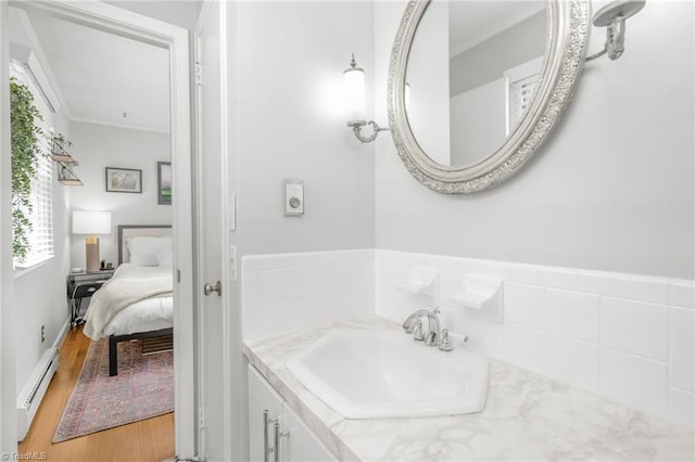 1315 Waybridge Ln, Winston-Salem, NC 27103 - bathroom with a baseboard radiator, vanity, connected bathroom, and wood finished floors