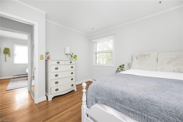 1315 Waybridge Ln, Winston-Salem, NC 27103 - bedroom featuring wood finished floors, a baseboard radiator, and ornamental molding