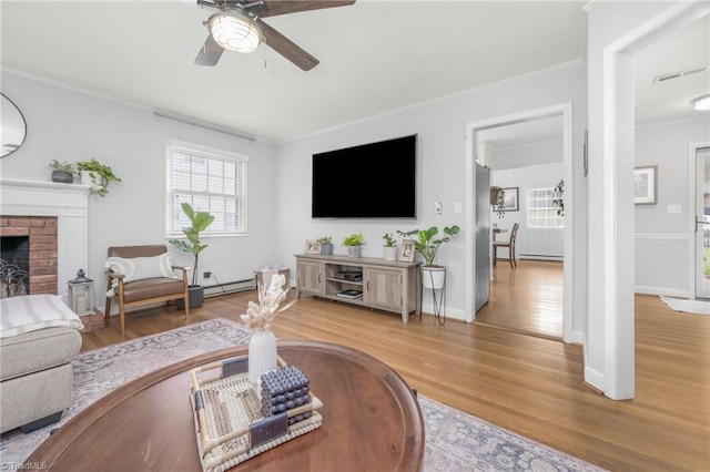 1315 Waybridge Ln, Winston-Salem, NC 27103 - living room featuring ceiling fan, ornamental molding, light wood-style flooring, and a fireplace