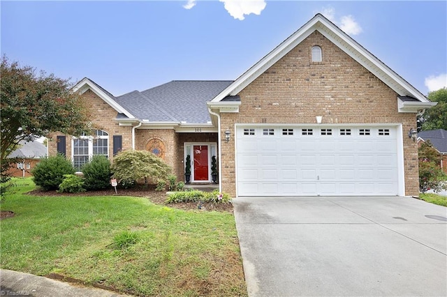 view of front of property featuring an attached garage, concrete driveway, a front lawn, and brick siding