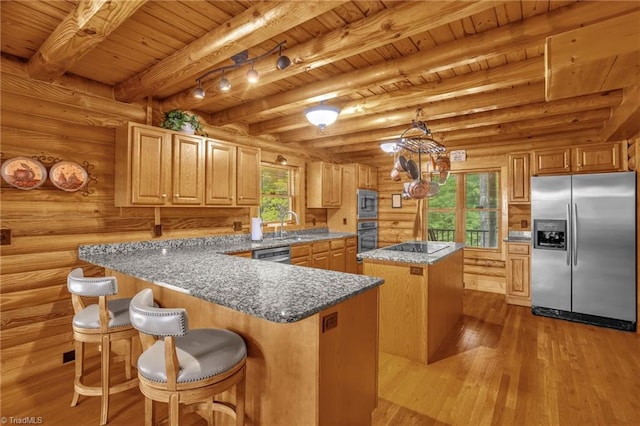 2235 Buck Mountain Rd, Purlear, NC 28665 - kitchen with appliances with stainless steel finishes, a wooden ceiling with exposed beams, a kitchen island, wood finished floors, and a peninsula