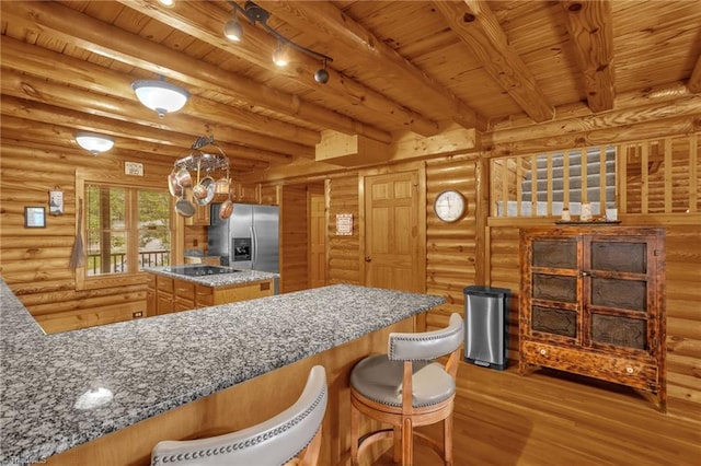 2235 Buck Mountain Rd, Purlear, NC 28665 - kitchen featuring stainless steel fridge, a wooden ceiling with exposed beams, wood finished floors, light stone countertops, and a center island