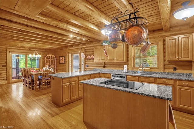 2235 Buck Mountain Rd, Purlear, NC 28665 - kitchen featuring a center island, a wood ceiling with exposed beams, light wood-style floors, log walls, and black electric stovetop