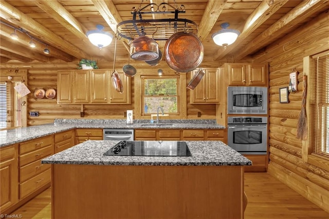 2235 Buck Mountain Rd, Purlear, NC 28665 - kitchen featuring appliances with stainless steel finishes, rustic walls, a wood ceiling with exposed beams, a kitchen island, and light stone counters