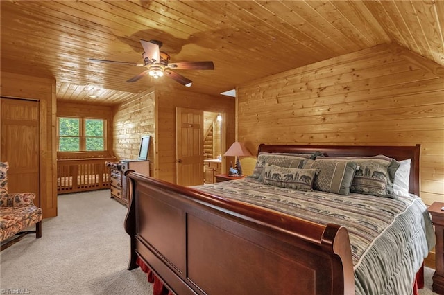 2235 Buck Mountain Rd, Purlear, NC 28665 - bedroom featuring wood ceiling, wood walls, light colored carpet, and a ceiling fan