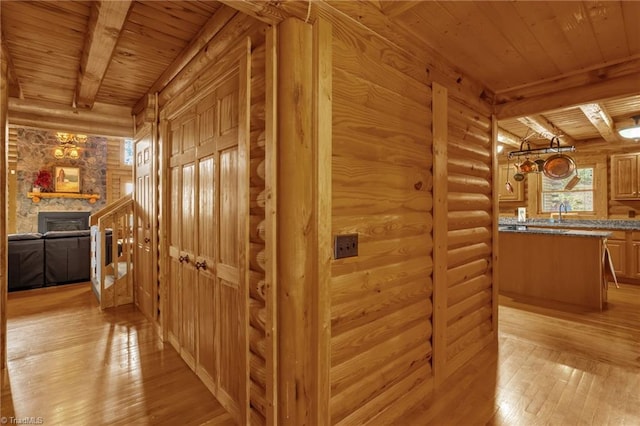 2235 Buck Mountain Rd, Purlear, NC 28665 - hall featuring a wooden ceiling with exposed beams, rustic walls, and light wood-type flooring