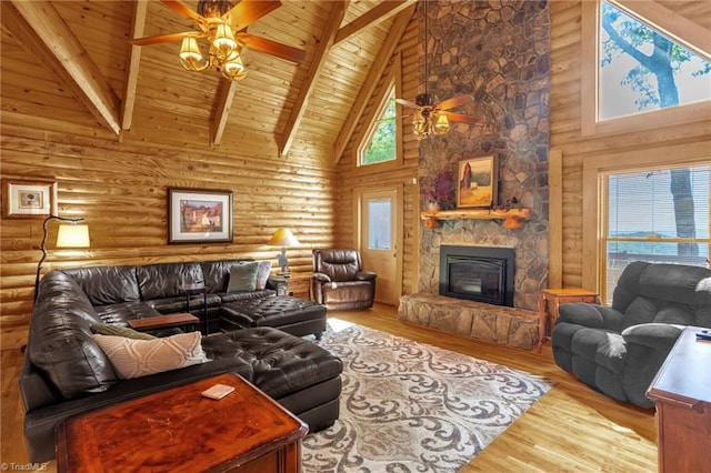 2235 Buck Mountain Rd, Purlear, NC 28665 - living area with a ceiling fan, high vaulted ceiling, a wooden ceiling with exposed beams, wood finished floors, and a stone fireplace