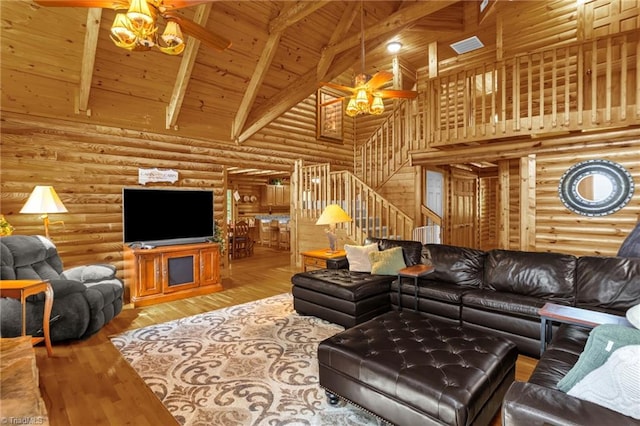 2235 Buck Mountain Rd, Purlear, NC 28665 - living area featuring ceiling fan, high vaulted ceiling, a wood ceiling with exposed beams, stairway, and log walls