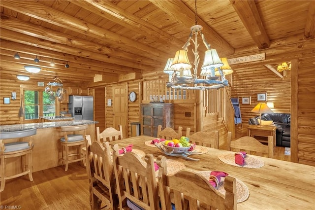 2235 Buck Mountain Rd, Purlear, NC 28665 - dining area with rustic walls, light wood-style flooring, a chandelier, and a wooden ceiling with exposed beams