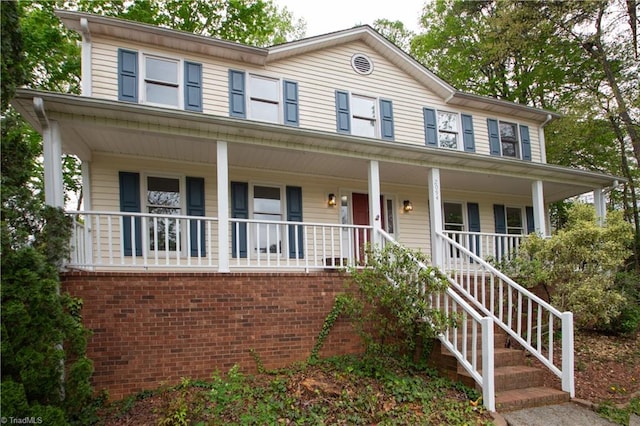 colonial-style house featuring a porch