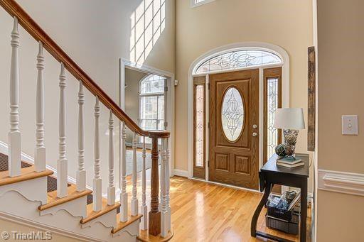 entryway with a high ceiling and light hardwood / wood-style floors