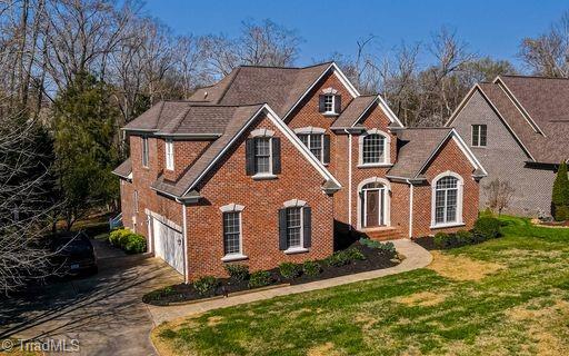 view of property featuring a front lawn and a garage