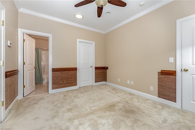 unfurnished bedroom with ceiling fan, ensuite bathroom, light colored carpet, and ornamental molding