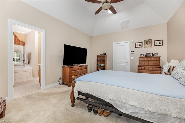 bedroom featuring ceiling fan, light colored carpet, lofted ceiling, and ensuite bathroom