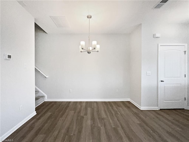 unfurnished dining area with dark hardwood / wood-style floors and a notable chandelier