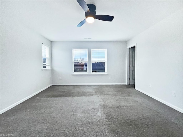 carpeted spare room featuring ceiling fan