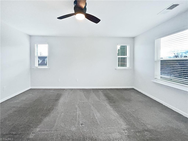 carpeted spare room featuring ceiling fan