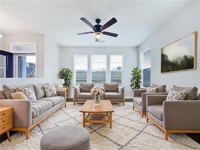 living room featuring ceiling fan and light wood-type flooring