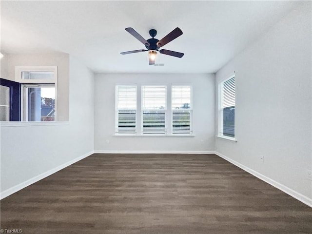 spare room with dark hardwood / wood-style flooring and ceiling fan