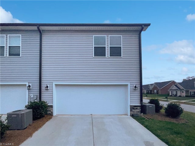 5810 Crestlawn Ct, Pfafftown, NC 27040 - view of front of home with central AC, stone siding, concrete driveway, and an attached garage