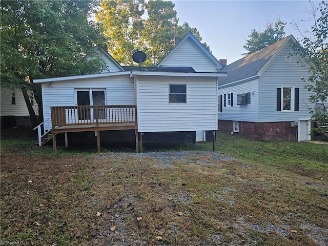 rear view of property with a wooden deck and a yard