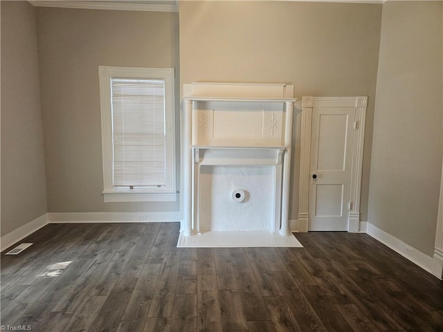 unfurnished living room with crown molding, baseboards, visible vents, and dark wood-type flooring