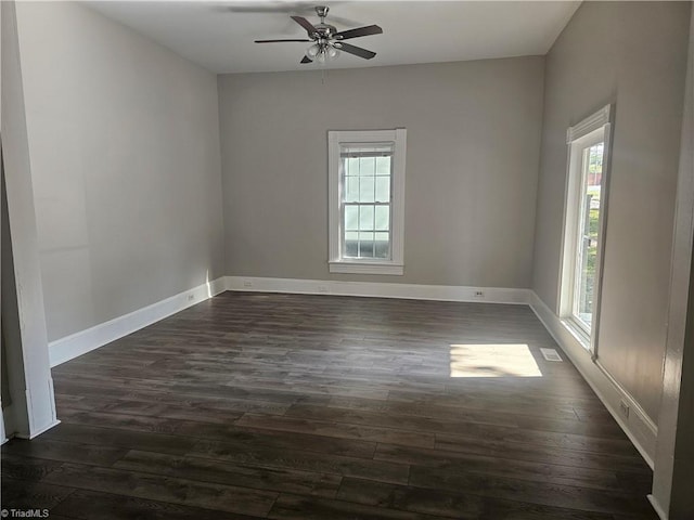 unfurnished room featuring dark wood-type flooring, ceiling fan, and a healthy amount of sunlight